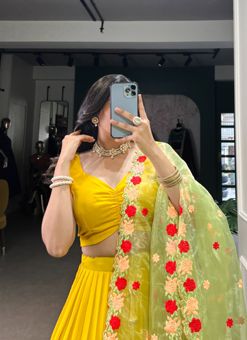 Haldi ceremony ruffle georgette lehenga choli paired with floral organza dupatta.